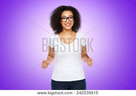 body positive and people concept - happy african american woman in white t-shirt and glasses pointing fingers to herself over ultra violet background