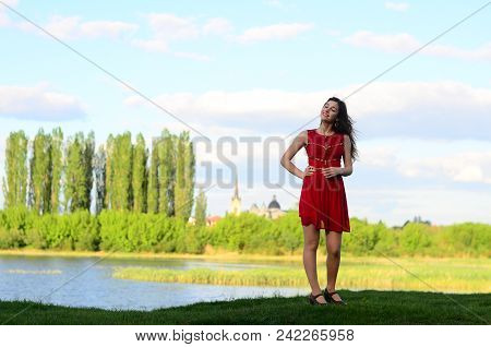 Happy Smile Girl On The Beautiful Old City Square Dancing In The Rain, Wears Stylish Red Velvet Shor