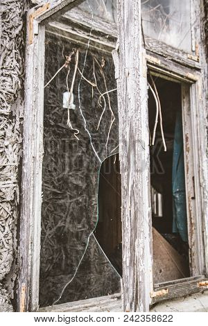 Broken Window Of An Abandoned House, With Naked Walls (no Plasterwork)