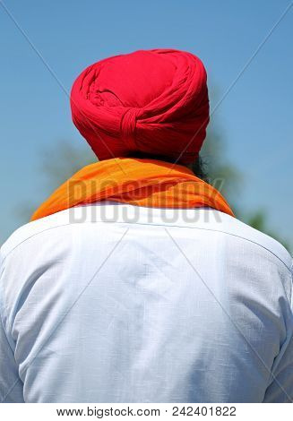 Adult Man Wearing Red Turbant And White Shirt