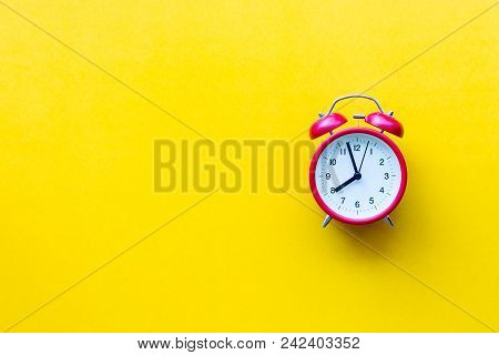 A Red Alarm Clock With Eight O'clock On Yellow  Background With Copyspace