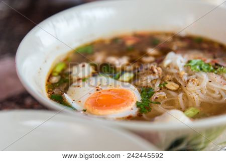 Spicy Tom Yum Noodle With Pork And Egg For Sale At Thai Street Food Market Or Restaurant In Thailand