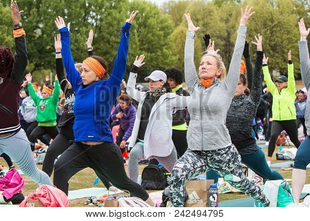 Atlanta, Ga - April 2018:  Women Do A Version Of The Warrior Pose As They Take Part In A Massive Gro