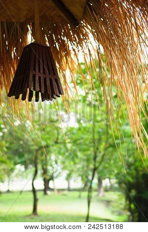 Hanging Lanterns At The Corner Of The Cottage In The Forest, With A Beautiful Green Tree Background.