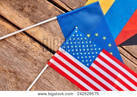 American And Eu Flag. Top View, Flat Lay. Wooden Desk Surface Background.