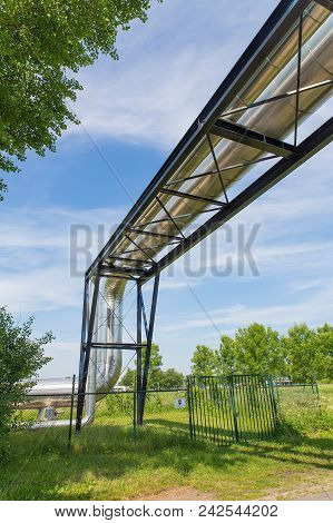 Large Metal Gas Pipeline Through Blue Sky