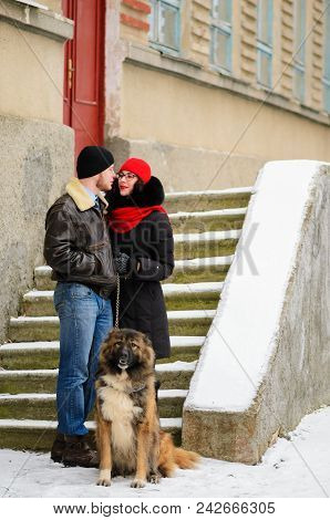 Happy Couple With Dogs In Winter Forest. Lovely Moments Outdoor