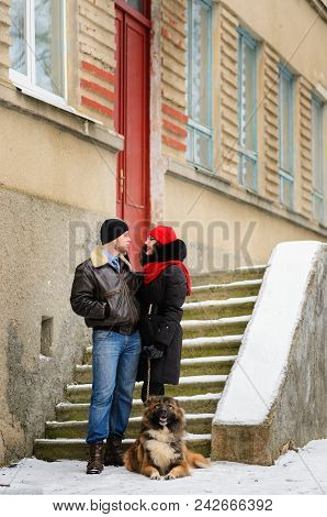 Happy Couple With Dogs In Winter Forest. Lovely Moments Outdoor