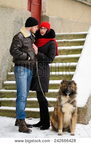 Happy Couple With Dogs In Winter Forest. Lovely Moments Outdoor