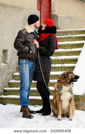 Happy Couple With Dogs In Winter Forest. Lovely Moments Outdoor