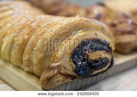 Splendid Original Homemade Swiss Roll With Poppy Seeds On The Wooden Plate With Shining Sugar Jam. D