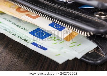 Open Wallet With Euro Cash 10 20 50 100 On A Wooden Background. Men's Wallet With Cash Euro.
