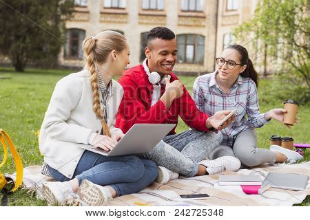 Funny Jokes. Beautiful Pleasant Girls Laughing Out Loud While Their Fellow Student Joking Funnily In