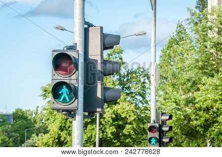 Green Traffic Light Signal For Pedestrians On The Crosswalk In The City