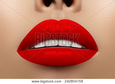 Close-up Macro Shot Of Female Mouth. Sexy Glamour Red Lips Makeup With Sensuality Gesture. Bloody Li