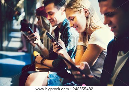 Diverse friends using their phones