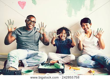 Black family painting the house wall