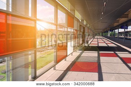 Train On The Railroad Tracks During Sunset. Perron At The Train Station.