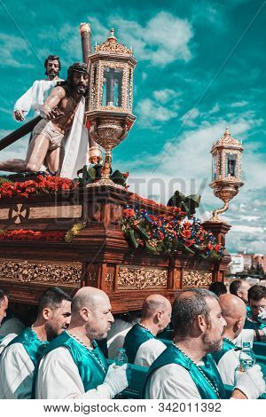 Merida, Spain. April 2019: A Group Of Bearers, Called Costaleros, Carrying A Religious Float