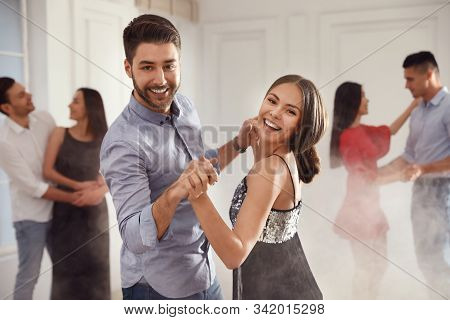 Lovely Young Couple Dancing Together At Party
