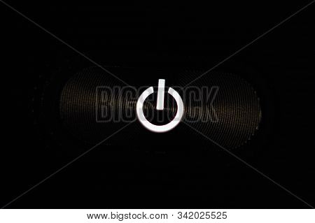 Macro Photograph Of An On Off Power Button On A Silver Plated Device
