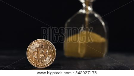 Bitcoin Hodl For Years And Get Rich Concept, Time Is Running Out. Bitcoin Coin Next To Hourglass