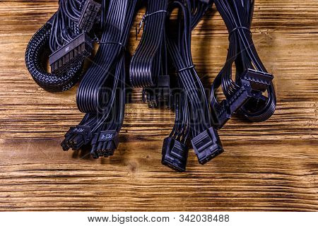 Set Of Computer Psu Cables On Wooden Background