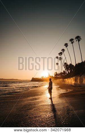 Men Watches The Sunset At The Beach