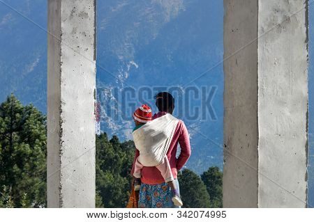 Reang Tribal Indian Woman Mother Carrying Baby On Back Wrap His Kid In A Piggy Back( A Traditional C