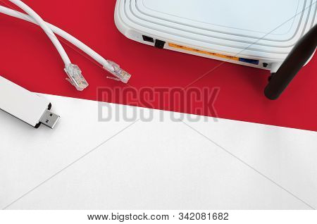 Indonesia Flag Depicted On Table With Internet Rj45 Cable, Wireless Usb Wifi Adapter And Router. Int