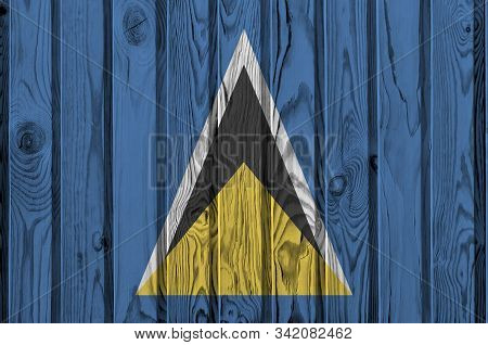 Saint Lucia Flag Depicted In Bright Paint Colors On Old Wooden Wall. Textured Banner On Rough Backgr