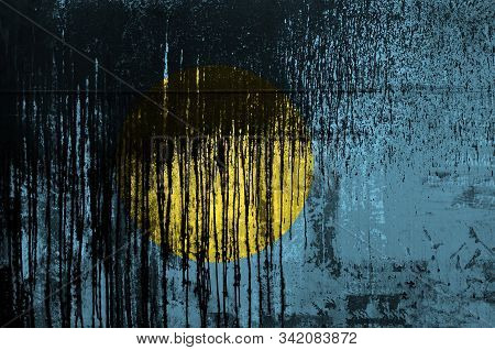 Palau Flag Depicted In Paint Colors On Old And Dirty Oil Barrel Wall Closeup. Textured Banner On Rou