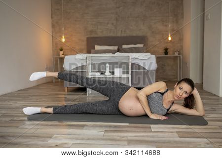 Pregnant Woman Working Out At Home During The Third Trimester Practising Healthy And Active Lifestyl