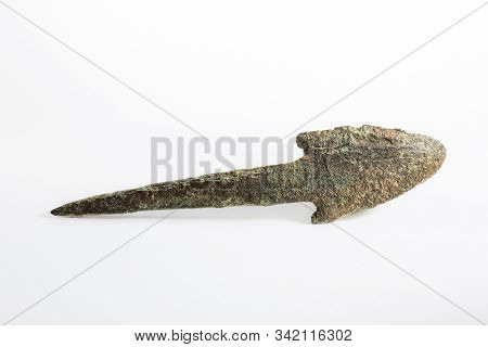 Ancient Arrowhead On White Background. Macro Photography.