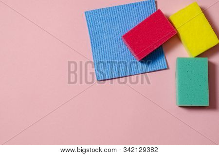 Multi-colored Inoperes For Cleaning The House On A Colored Background With A Place For Text