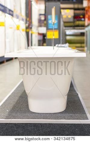 White Bathtubs In A Hardware Store. Vertical Photo