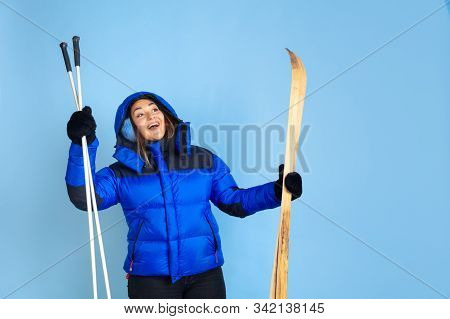 Skii Lover. Caucasian Womans Portrait On Blue Studio Background. Beautiful Female Model In Warm Clot