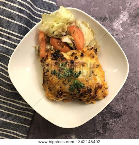 Lasagna Al Forno With Sauce Bolognese And Salad.