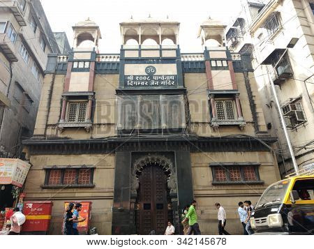 Mumbai, India - December, 2019: Jain Digambar Temple In Mumbai With Old Buildings And People Walking