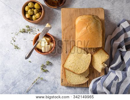 Fresh Homemade Crisp Bread  And Slices With Olive Oil, Butter And Green Olives, Top View.  Baking Co