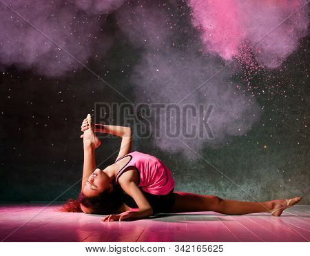 Young Athletic Girl Gymnast Is Doing Gymnastic Exercises On The Floor Does Stretching With One Her L