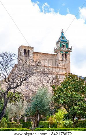 The Building Of The Carthusian Monastery Of Valldemossa, In Valldemossa, Mallorca, Spain Surrounded 