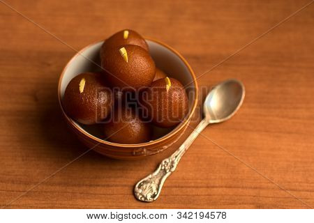 Gulab Jamun In Bowl On Wooden Background. Indian Dessert Or Sweet Dish.