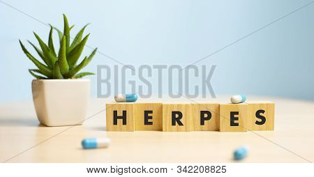 Herpes - Word From Wooden Blocks With Letters, Viral Diseases Herpes Viruses Concept, Blue Backgroun