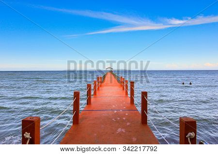 Perspective View Of A Cement Pier On The Seashore With Clear Blue Sea At Sawangan Beach,kuala Penyu,