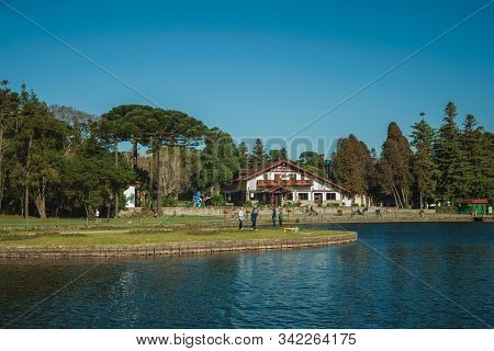 Gramado, Brazil - July 21, 2019. Wooded Park With The Joaquina Rita Bier Lake And Old House In Germa