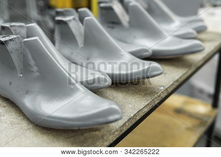 Plastic Lasts Used In The Manufacture Of Shoes. Row Of Plastic Shoe Lasts Used To Manufacture Modern