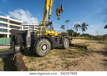 Yellow Automobile Crane With Risen Telescopic Boom Outdoors. Mobile Construction Crane On A Construc