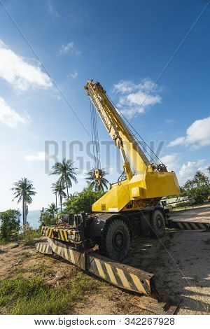 Yellow Automobile Crane With Risen Telescopic Boom Outdoors. Mobile Construction Crane On A Construc