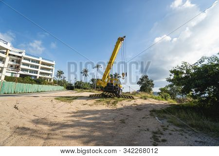 Yellow Automobile Crane With Risen Telescopic Boom Outdoors. Mobile Construction Crane On A Construc
